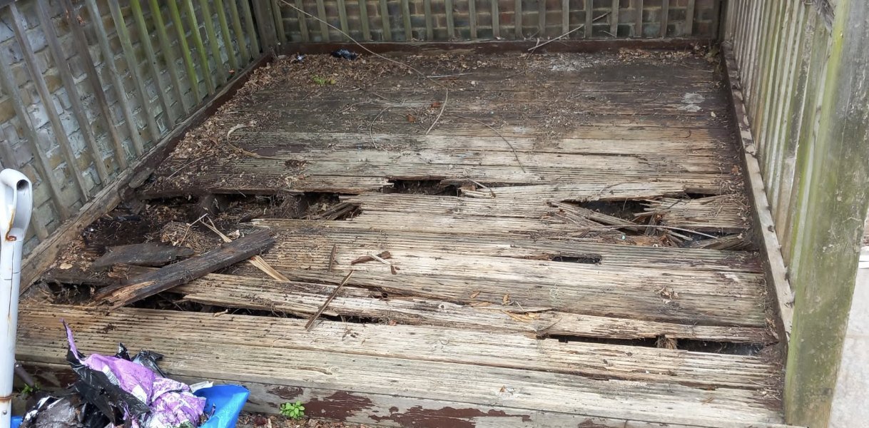 Rotten and unsafe old decking boards before replacement