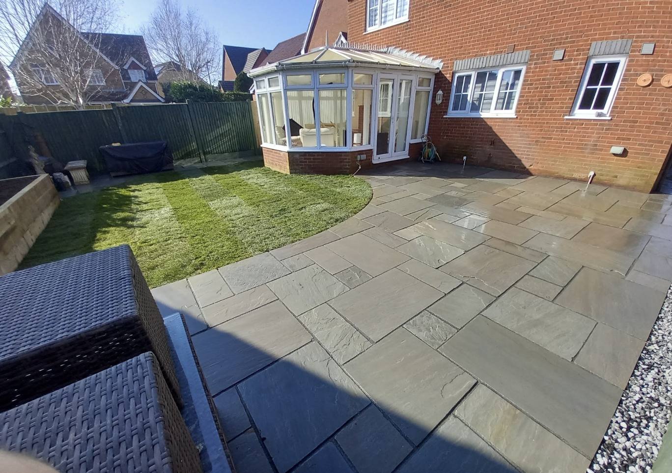 Sandstone patio wrapping around a conservatory, Kent