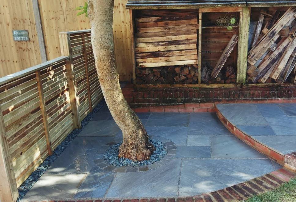 New riven sandstone patio with seating area by Lawn Ranger Landscapes