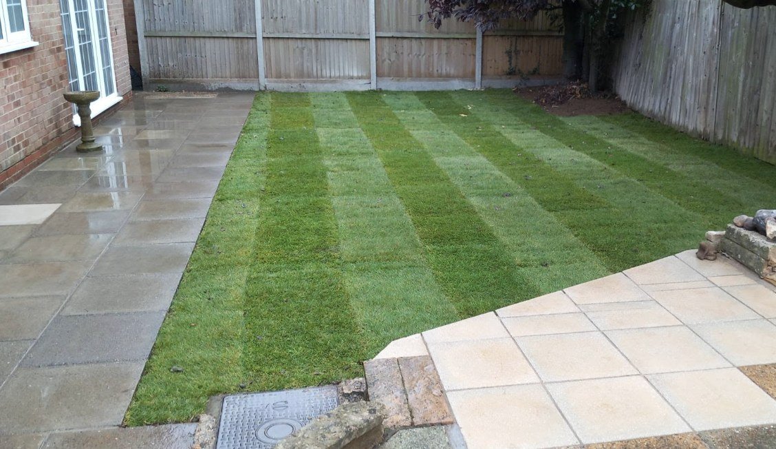 Striped lawn between two sandstone patios, Kent